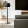 A living room scene with a pair of black floor stands for speakers, a TV, and a sofa. Produktbild-Vorschau