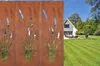 A garden scene with a house and lawn, featuring decorative metal screens with cattail designs. Podgląd zdjęcia produktu