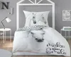 A bedroom scene with a bed dressed in horse-themed bedding. Voir les images du produit