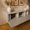 A modern, minimalist living room setting with a wall-mounted TV lowboard. Produktbild-Vorschau