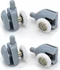 Four shower door rollers are displayed against a white background. Náhľad obrázku produktu