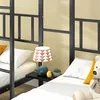 Close-up view of a bunk bed with bedding and a lamp. Voir les images du produit