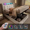 A modern bed with storage, featuring LED lighting and USB ports, shown in a bedroom setting with luggage stored underneath. Produktbild-Vorschau