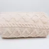 A close-up side view of a beige, textured blanket. Anteprima dell’immagine prodotto