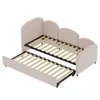 A light pink upholstered daybed with a pull-out trundle bed, shown with both beds extended and their wooden slat bases visible. Anteprima dell’immagine prodotto