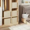Storage boxes in a closet next to a bed. Produktbild-Vorschau