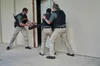 Law enforcement officers in tactical gear are practicing a door breach simulation. Produktbild-Vorschau
