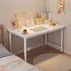 A white desk with a laptop, lamp, and other accessories, set up in a bedroom next to a bed. Anteprima dell’immagine prodotto