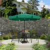 A patio set with a green umbrella, table, and chairs in a garden setting. Produktbild-Vorschau