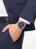 A man's hand wearing a watch is placed in his pocket. Produktbild-Vorschau