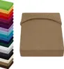 A stack of colorful fitted sheets and a single beige fitted sheet. Produktbild-Vorschau