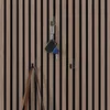 Hooks on a slatted wooden wall, with keys and a bag hanging from them. Voir les images du produit