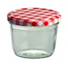 A clear studio shot of a glass jar with a red and white checkered lid. Produktbild-Vorschau