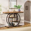 A console table with shelves is placed in a hallway next to an arched doorway. The table is decorated with a vase of greenery, books, a vintage radio, and a clock. Voir les images du produit