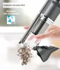 A hand is emptying dust from a handheld vacuum cleaner. Produktbild-Vorschau