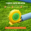 A yellow and green blower connected to a blue inflatable tube, placed on green grass. Voir les images du produit