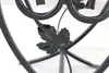A close-up shot of a black metal plant stand with a leaf motif. Náhled obrázku produktu