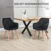 Two black chairs are placed in front of a wooden dining table in a room. Náhled obrázku produktu