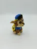 A plush toy dog wearing a blue hat and blue uniform, with a yellow loop attached to its collar. Náhled obrázku produktu