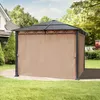 A gazebo with taupe side panels is set up on a paved patio in a backyard with green grass and trees. Podgląd zdjęcia produktu