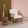 A modern armchair and side table with decorative objects are set against a two-toned wall. Anteprima dell’immagine prodotto