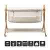 A baby bassinet on a wooden stand with wheels, presented on a white background. Náhled obrázku produktu