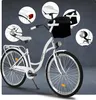 A white bicycle with various close-up details highlighted in circles against a dark gray background. Produktbild-Vorschau