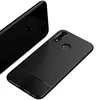 Two black phone cases with a carbon fiber texture are shown against a white background. One case is shown from the back, and the other is shown from the front-top angle. Produktbild-Vorschau