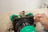 A person's hands are installing a Hansgrohe iBox universal 2 Grundkörper onto a wooden board. Podgląd zdjęcia produktu
