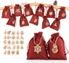 A collection of red fabric drawstring bags with wooden ornaments, arranged on a wooden rod and in a separate pile. Anteprima dell’immagine prodotto