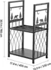 A black metal firewood rack with decorative cutouts of bears and trees. Podgląd zdjęcia produktu