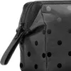 A close-up view of a black cosmetic bag with a polka dot pattern. Produktbild-Vorschau