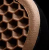 A close-up view of the sole of a shoe, showing the hexagonal tread pattern and the side of the sole. Náhled obrázku produktu