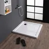 A modern bathroom scene featuring a square shower tray, a shelf with toiletries, and a shower fixture.