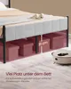 A bed frame with storage boxes underneath, and a robot vacuum cleaner on the floor. Produktbild-Vorschau