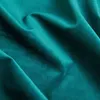 Close-up of teal fabric with folds and shadows. Podgląd zdjęcia produktu