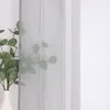 A sheer curtain with a plant in a vase in front of it. Produktbild-Vorschau