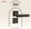 A black door handle set is displayed against a light, patterned background, framed by an archway graphic. Produktbild-Vorschau