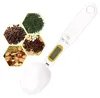 A digital spoon scale is shown next to four hexagonal insets containing various ingredients like coffee beans, herbs, and spices. Náhled obrázku produktu