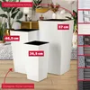 Three white planters of different sizes are displayed on a wooden floor with a rug and plants in the background. There are also swatches of different colors and textures on the right side of the image. Podgląd zdjęcia produktu