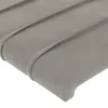 A close-up view of a gray fabric headboard with a textured surface and horizontal pleats. Produktbild-Vorschau