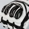 A close-up view of a motorcycle glove, showing the protective knuckle guards. Podgląd zdjęcia produktu