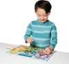A young boy is playing with a wooden puzzle board with various locks and latches. Produktbild-Vorschau