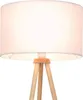 A close-up view of a tripod floor lamp with a white fabric shade and wooden legs. Podgląd zdjęcia produktu