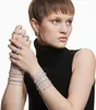 A woman wearing multiple rings and bracelets. Náhľad obrázku produktu