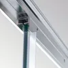 A close-up view of a shower door track and seal. Voir les images du produit