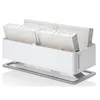 A white humidifier with four filters inside, resting on a gray stand. Produktbild-Vorschau