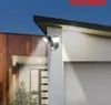 An outdoor LED floodlight mounted on the exterior wall of a modern house at dusk. Produktbild-Vorschau