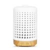 A white aroma diffuser with a light brown wooden base, set against a white background. Produktbild-Vorschau