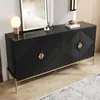 A black sideboard with gold accents is shown in a room with a wooden floor and a rug. Produktbild-Vorschau